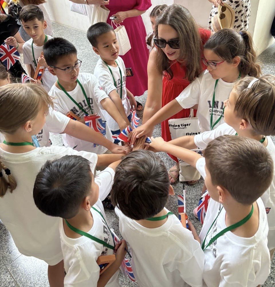 Children in INDIGO Champion t-shirts joining hands together