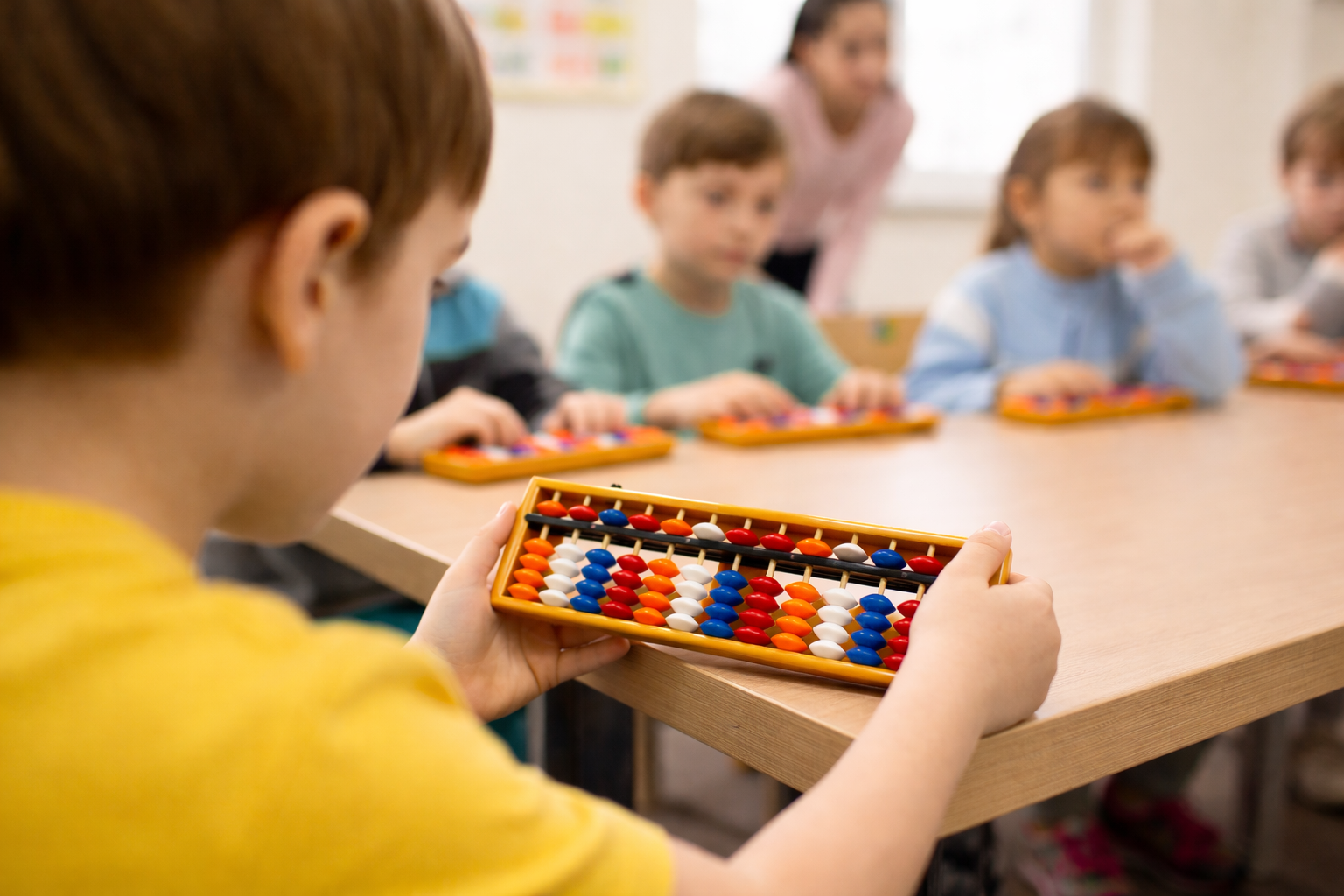 Children practising mental maths with abacuses in an INDIGO class